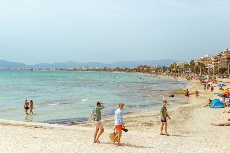 tourists on a crowded beach in summer